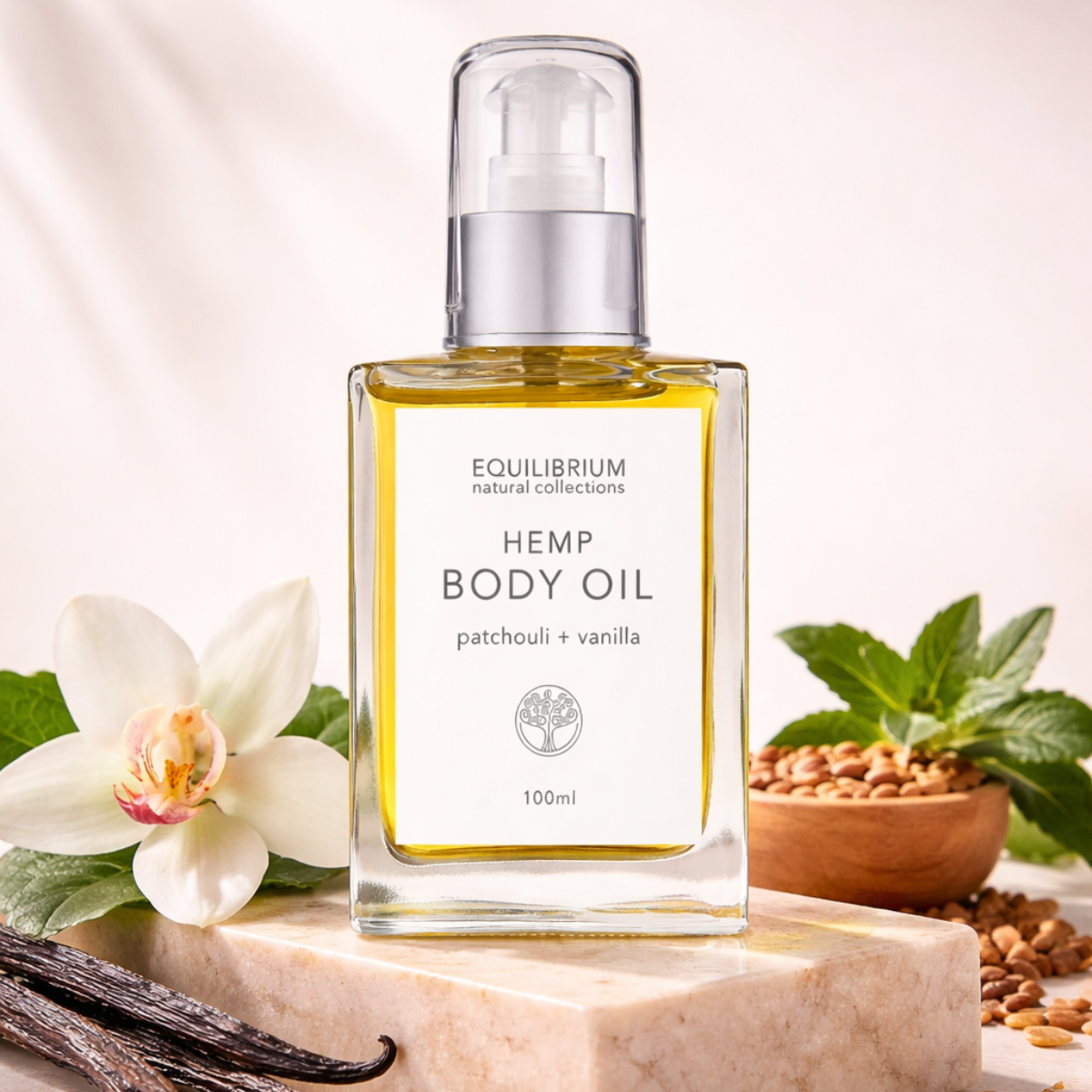 Bottle of hemp body oil with vanilla and patchouli on a marble surface