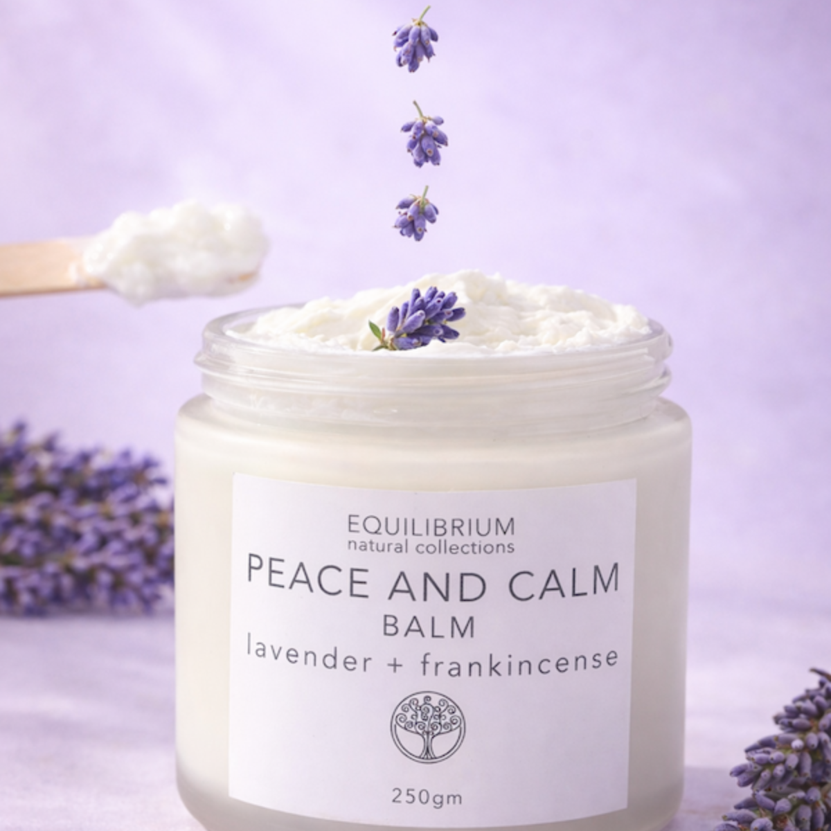 Jar of 'Peace and Calm' balm with lavender flowers on a purple background